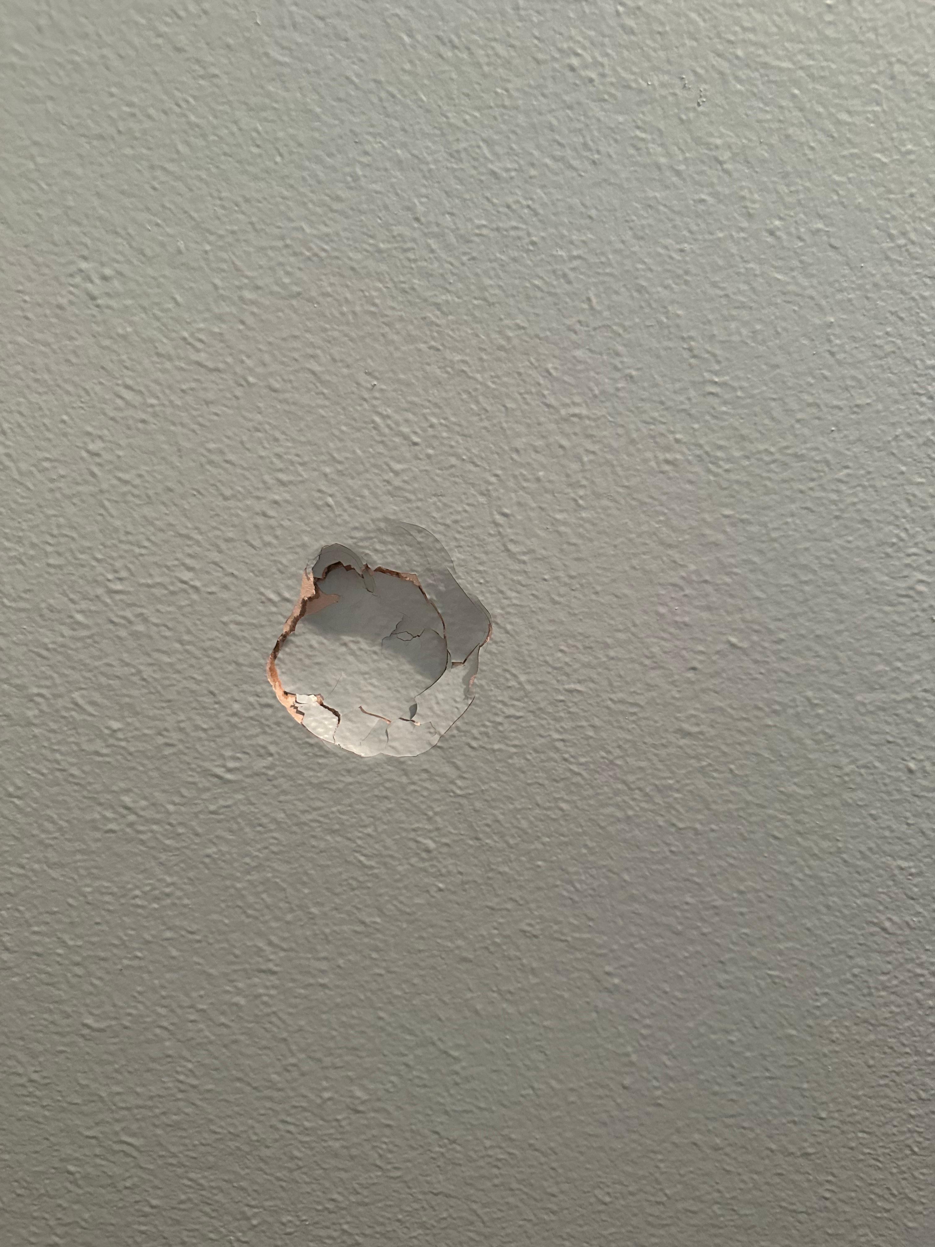 Area of damaged drywall being prepared for repair